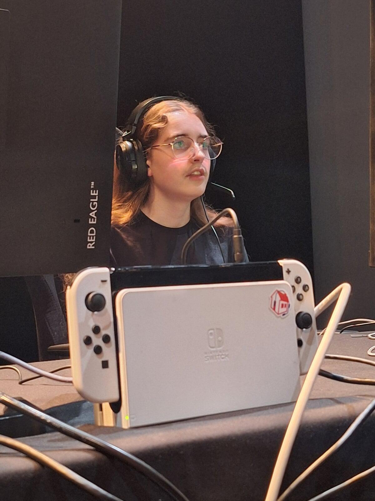 A girl from Dame Allan's concentrated on the game with a white Nintento Switch sat in front of her